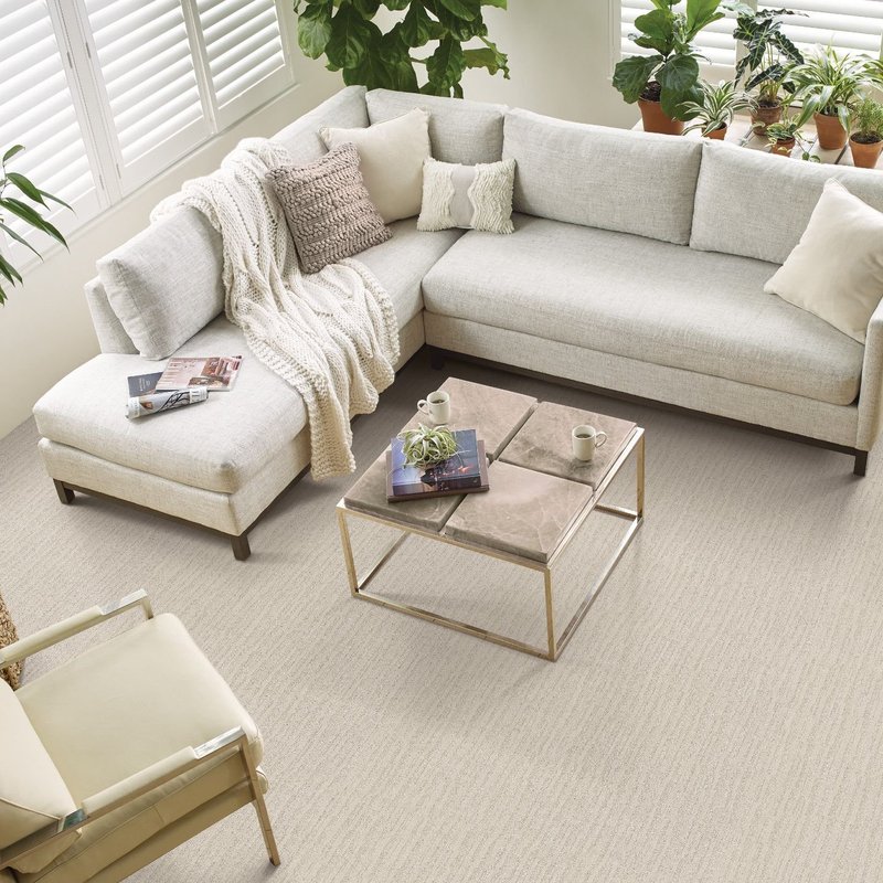 Photo of living room taken from above with corner sofa and beige carpet from New Horizon Carpets in the Hemet, CA area